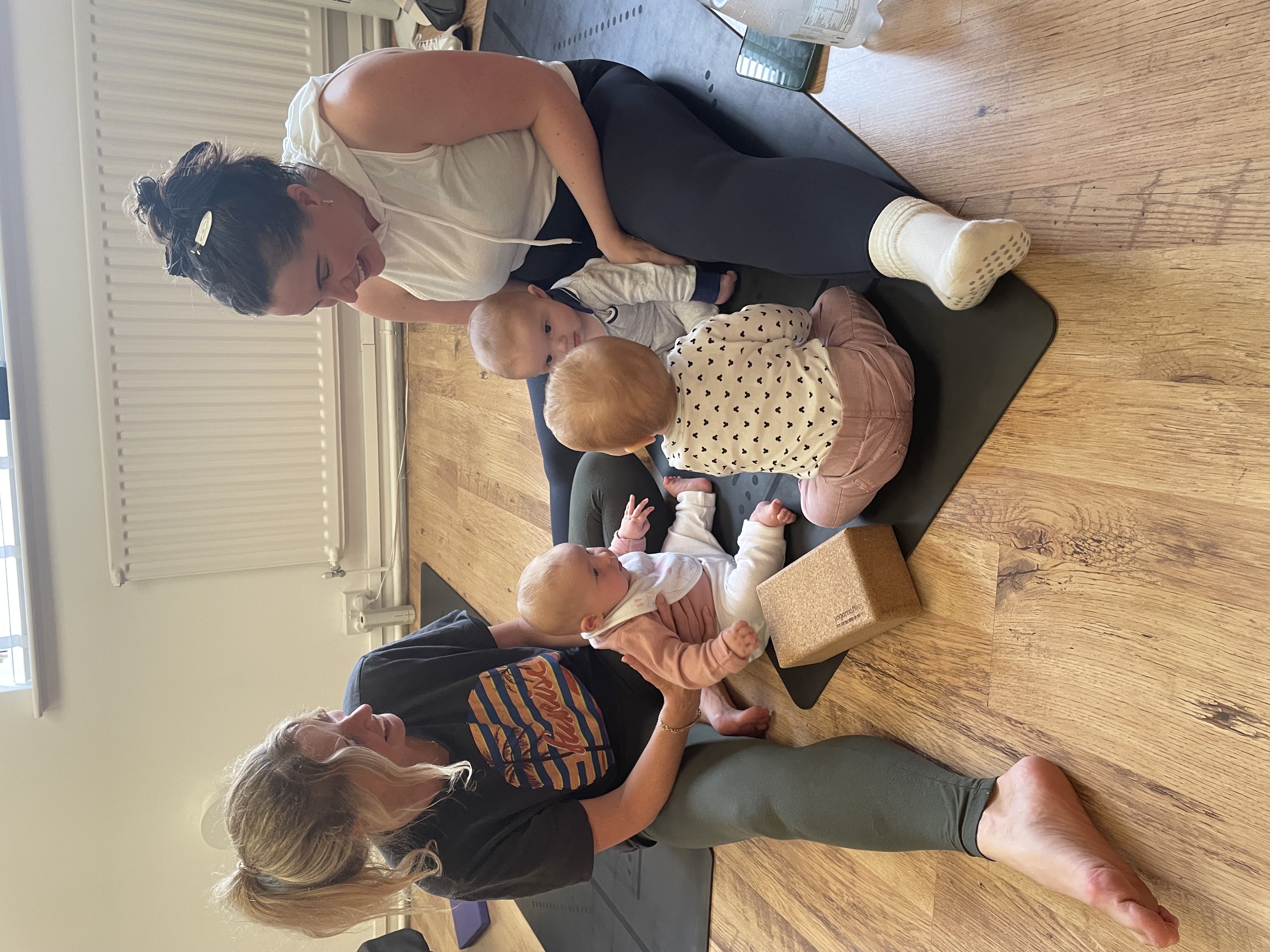Yogi & Bear postnatal yoga, two mums sat smiling with their babies