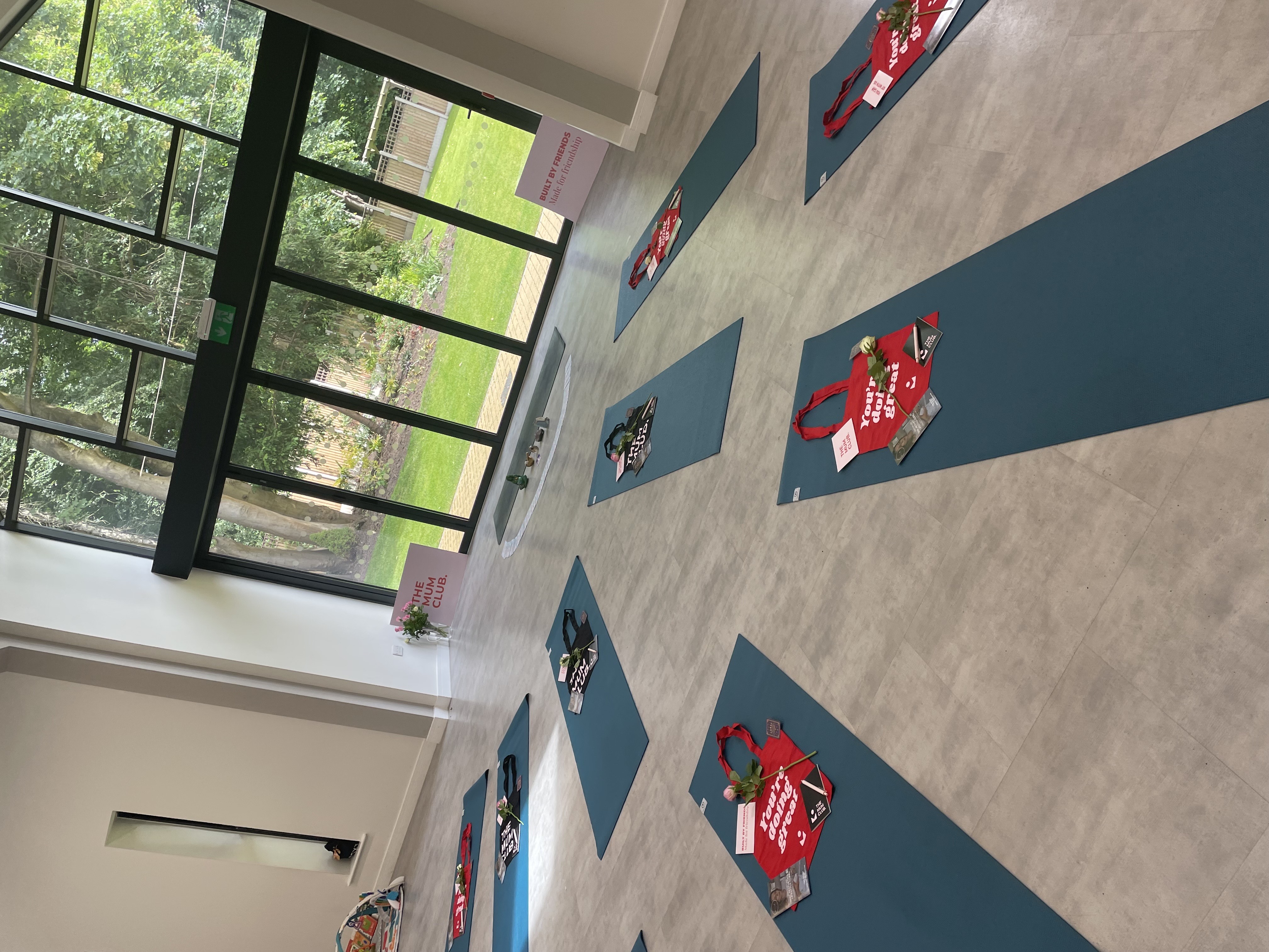 Mats set out with roses and welcome gifts for a corporate wellbeing event